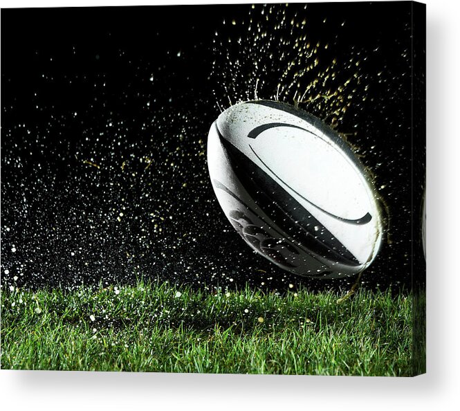 Grass Acrylic Print featuring the photograph Rugby Ball In Motion Over Grass by Thomas Northcut