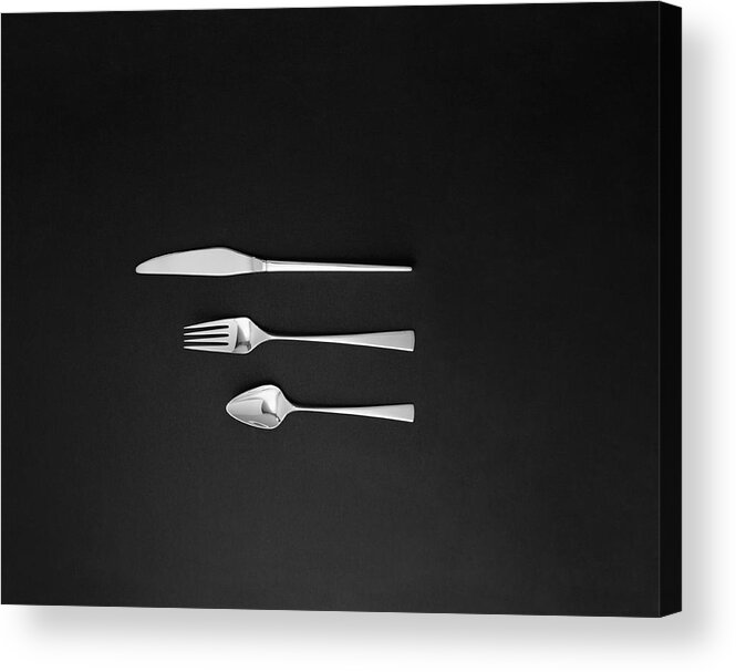 In A Row Acrylic Print featuring the photograph Spoon, Fork And Butter Knife On Black by Tom Kelley Archive