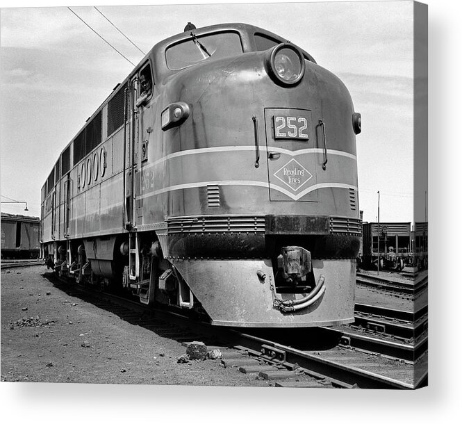 B&w Black And White 1940s 1950s 1939-1945 Adults Alone America American Anonymous Built By Carrier Diesel Electric Electro-motive Division Engineer Engine Exterior Freight Full-length Ggeneral Motors Head On Industry Line Locomotive Logo Low Angle Occupations Outdoors Pa Pennsylvania Powerful Railroad Railway Rail Reading Lines Reading Single Streamline Stylish Suburban Trains Transportation Travel Urban Usa Victory View Window Retro Vintage Nostalgic Old Fashioned Old Fashion Old Time Classic Acrylic Print featuring the photograph 1940s head on reading lines diesel electric railroad engine model EMD FT built by General Motors by Panoramic Images