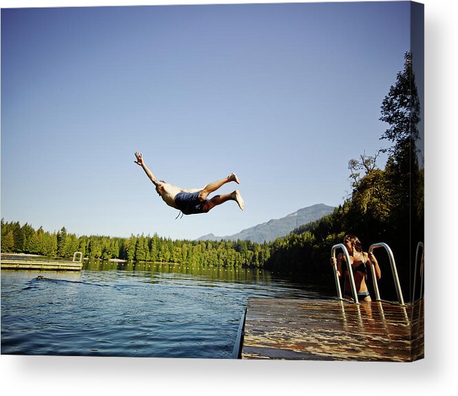 Tranquility Acrylic Print featuring the photograph Man Diving Off Dock Into Mountain Lake by Thomas Barwick