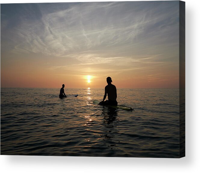 Young Men Acrylic Print featuring the photograph Surfers Sitting On Boards At Sunset by Dougal Waters