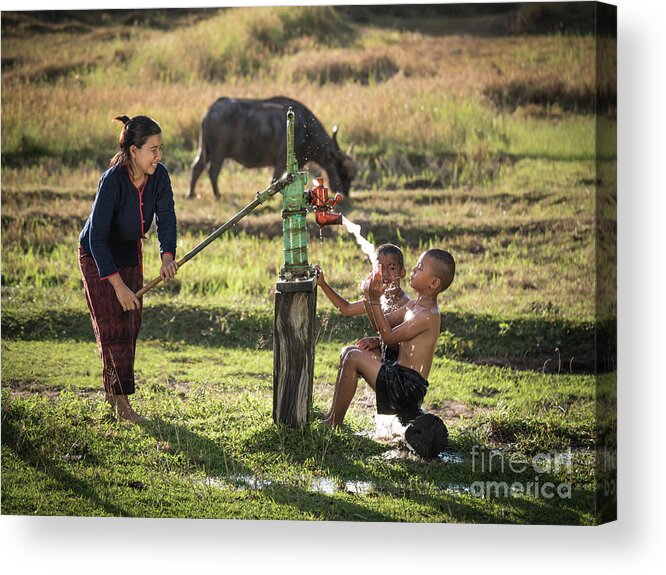 Sun Acrylic Print featuring the photograph Mother her sons shower outdoor from Groundwater pump. by Tosporn Preede