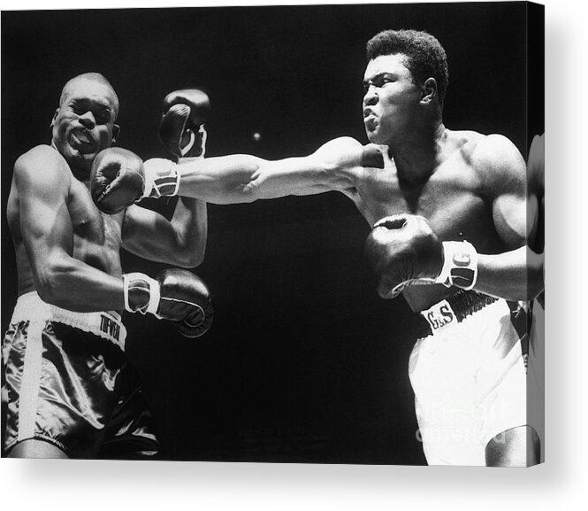 People Acrylic Print featuring the photograph Boxer Cassius Clay Punching Doug Jones by Bettmann
