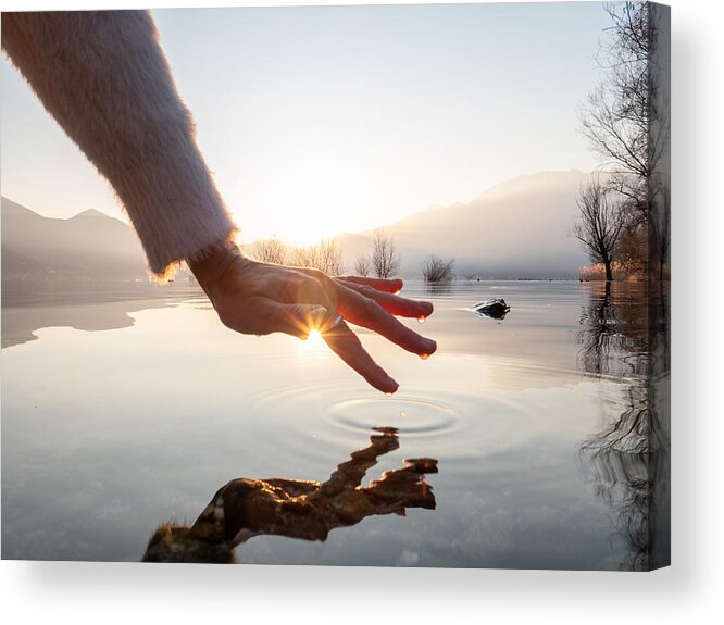Tranquility Acrylic Print featuring the photograph Detail of hand touching water surface of lake at sunset by Swissmediavision
