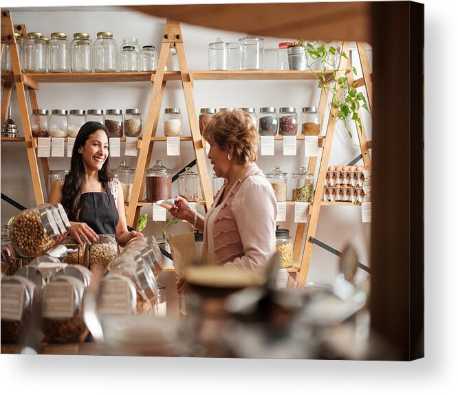 Working Acrylic Print featuring the photograph Happy hispanic employee and customer smiling at each other by Aldomurillo