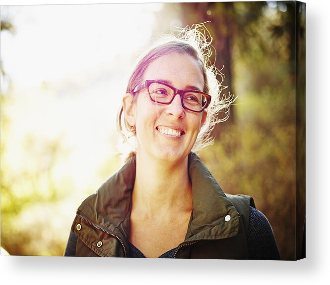 Mid Adult Women Acrylic Print featuring the photograph Smiling woman standing outdoors in forest by Thomas Barwick