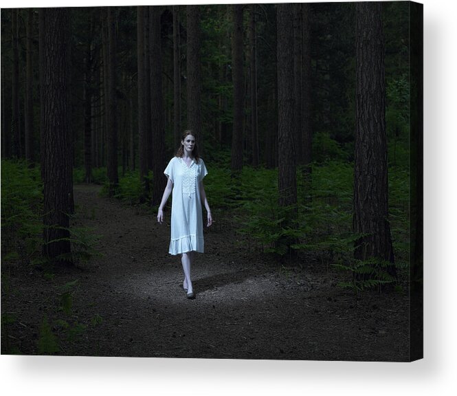 Spot Lit Acrylic Print featuring the photograph Young woman walking in forest by Michael Blann