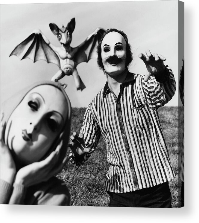 Fashion Acrylic Print featuring the photograph A Man And Woman Wearing Masks With A Bat Flying by Chadwick Hall