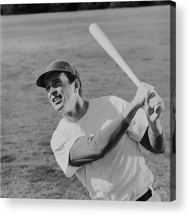 Sports Helmet Acrylic Print featuring the photograph Baseball player swinging baseball bat by Tom Kelley Archive