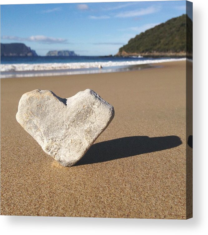 Water's Edge Acrylic Print featuring the photograph Heart Shaped Rock Sitting In Sand At by Jodie Griggs