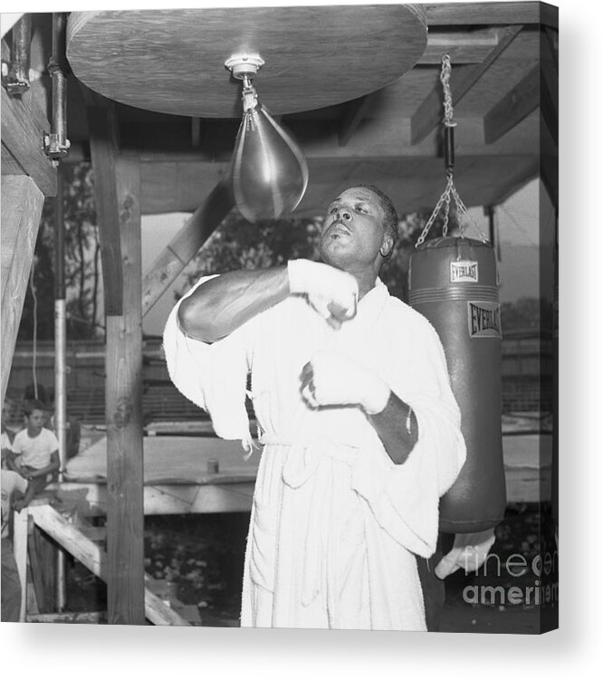 Adjusting Acrylic Print featuring the photograph Archie Moore Hitting Punching Bag by Bettmann