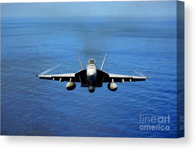 F A 18e Canvas Print featuring the photograph A FA-18 Hornet demonstrates air power. by Paul Fearn