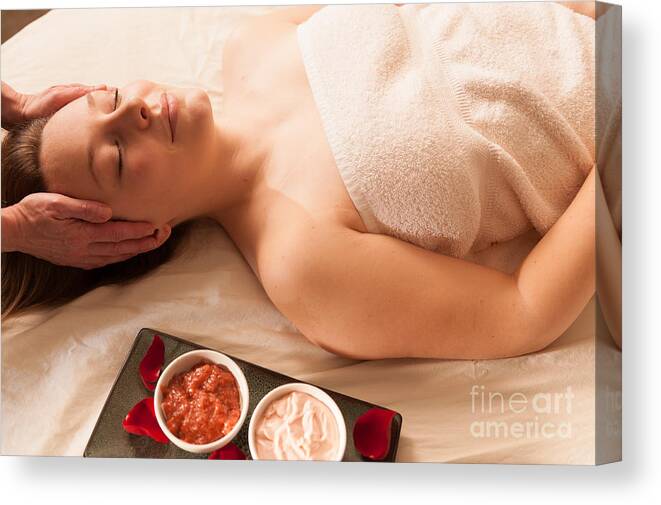 Attractive Canvas Print featuring the photograph Beautiful woman receiving a massage in a spa. #1 by Don Landwehrle