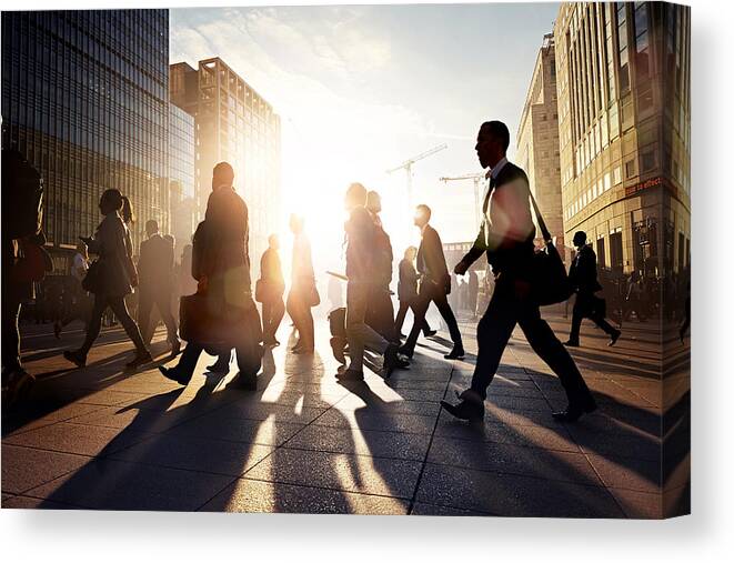Shadow Canvas Print featuring the photograph Employees walking to work in the city at sunrise #1 by Ezra Bailey