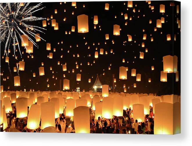 Hanging Canvas Print featuring the photograph Floating Lanterns Yi Peng In Thailand #1 by Nanut Bovorn