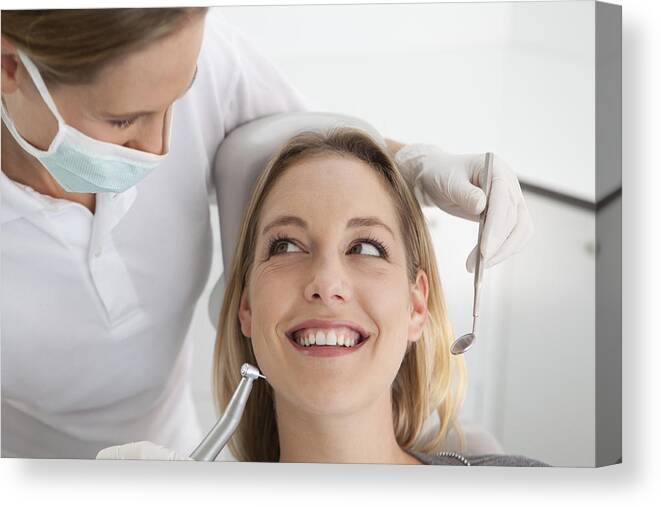 Expertise Canvas Print featuring the photograph Germany, Young woman getting her teeth examined by dentist #1 by Westend61
