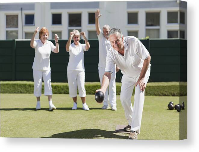 Heterosexual Couple Canvas Print featuring the photograph Older people playing lawn bowling #1 by Photo_Concepts
