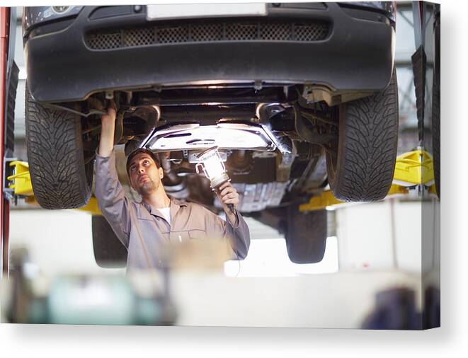 Expertise Canvas Print featuring the photograph Car mechanic at work in repair garage #3 by Westend61