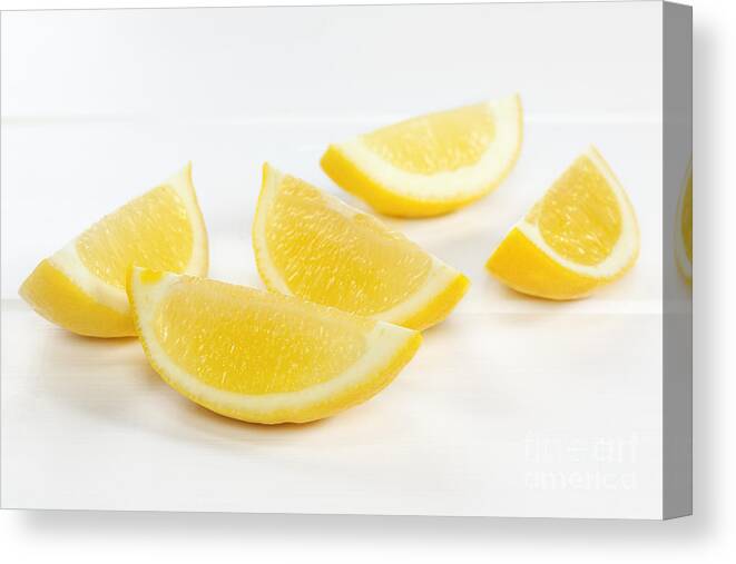 Lemon Canvas Print featuring the photograph Lemon Wedges on White Background #3 by Colin and Linda McKie