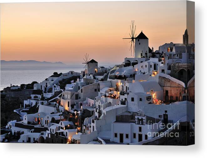 Santorini Canvas Print featuring the photograph Oia town during sunset #2 by George Atsametakis