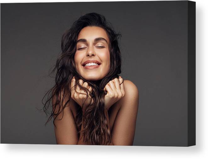People Canvas Print featuring the photograph Portrait of a young woman with a beautiful smile #4 by CoffeeAndMilk