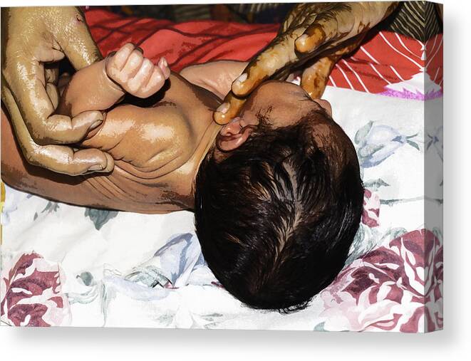 5 Day Old Baby Canvas Print featuring the photograph 5 day old Indian baby getting a light massage using mustard oil by Ashish Agarwal