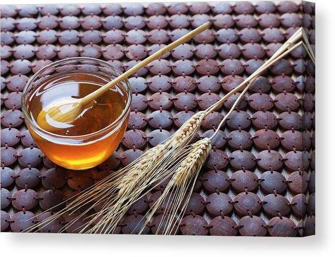 Wood Canvas Print featuring the photograph A Glass Bowl Of Honey And Wheat On A by Juan Silva