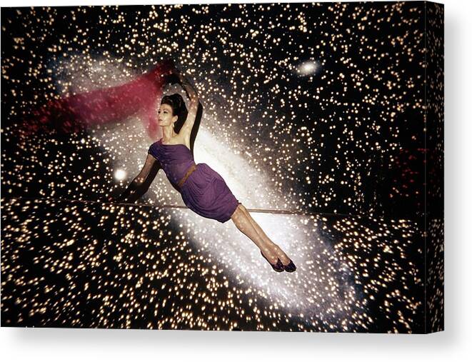 Fashion Canvas Print featuring the photograph A Model Against A Galaxy Backdrop by John Rawlings