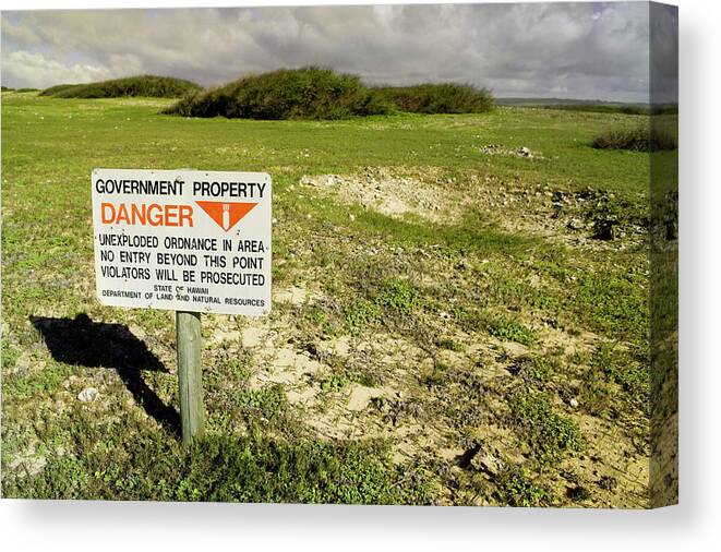 Aftermath Canvas Print featuring the photograph A Sign Warns Of Dangerous Unexploded by Jonathan Kingston