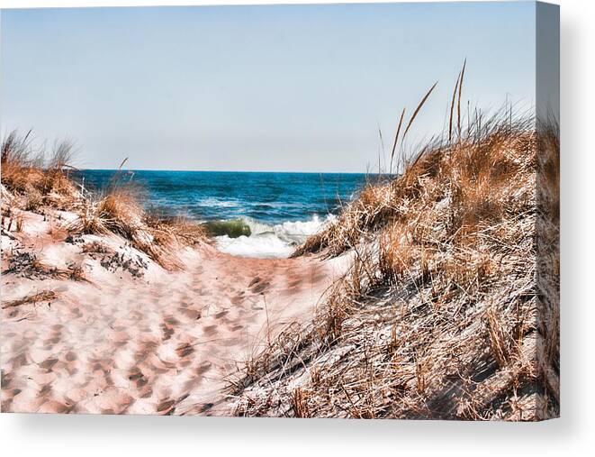 Beach Retaining Fence Canvas Print featuring the photograph A walk out to the water by Jeff Folger