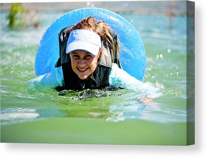 10-11 Years Canvas Print featuring the photograph A Woman Floats And Swims On An Inner by Steve Glass