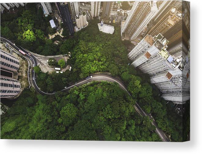 Scenics Canvas Print featuring the photograph Aerial view of curve road in forest against buildings in Hong Kong by Kiyoshi Hijiki