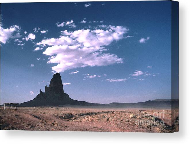Desolate Canvas Print featuring the photograph Agathia Peak Monument Valley by Tom Wurl