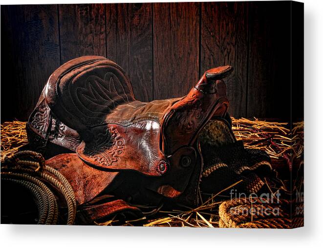 Saddle Canvas Print featuring the photograph An Old Saddle by Olivier Le Queinec
