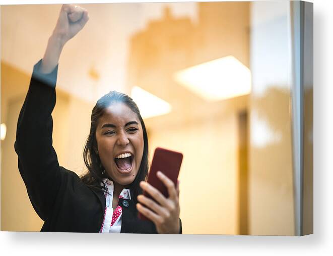 New Business Canvas Print featuring the photograph Asian Business Woman Celebrating with Mobile Phone by FG Trade
