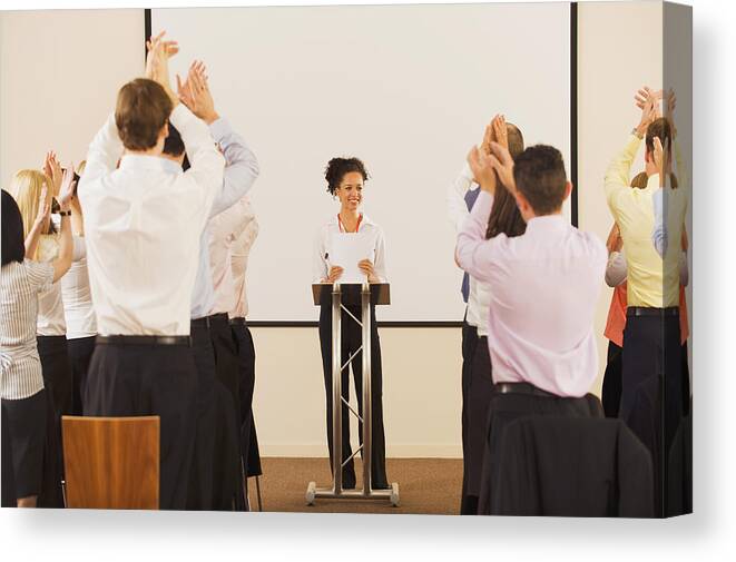 Young Men Canvas Print featuring the photograph Audience applauding businesswoman at podium by Jacobs Stock Photography Ltd