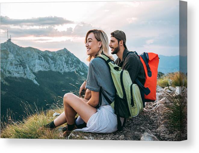 Young Men Canvas Print featuring the photograph Beautiful Young Couple Relaxing After Hiking And Taking A Break by DaniloAndjus