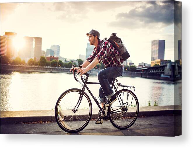 Young Men Canvas Print featuring the photograph Bike Commuter in Portland Oregon by RyanJLane