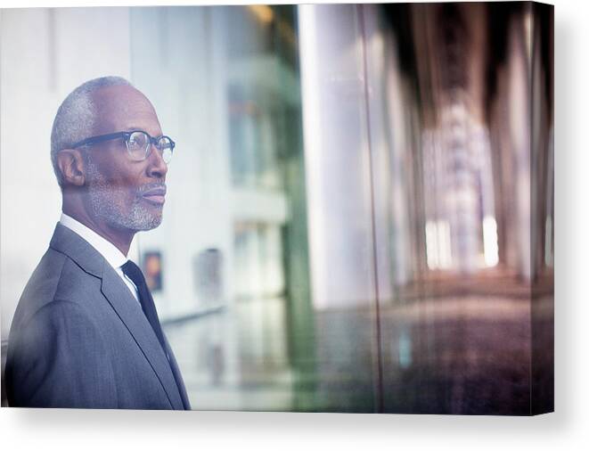 Corporate Business Canvas Print featuring the photograph Black Businessman Looking Out Window by Hill Street Studios Llc