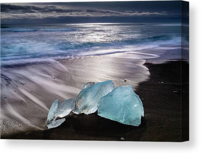 Water's Edge Canvas Print featuring the photograph Blue Ice-black Sand Jokulsarlon Beach by Larry Gerbrandt