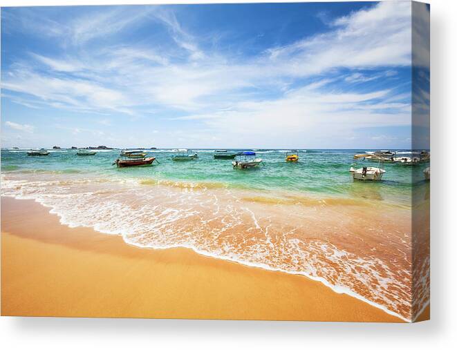 Water's Edge Canvas Print featuring the photograph Boats On Beach - Hikkaduwa Sri Lanka by Cinoby