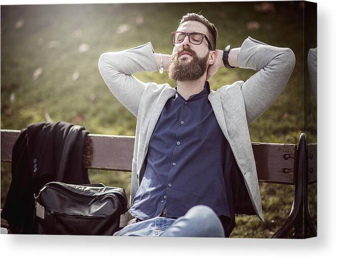 Young Men Canvas Print featuring the photograph Businessman Relaxing On The Bench After Work by DaniloAndjus