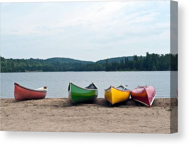 Lake Canvas Print featuring the photograph Canoes on the lake by Marek Poplawski
