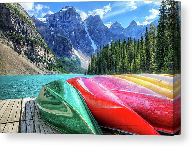 Snow Canvas Print featuring the photograph Cayaks On The Moraine Lake by Bike maverick