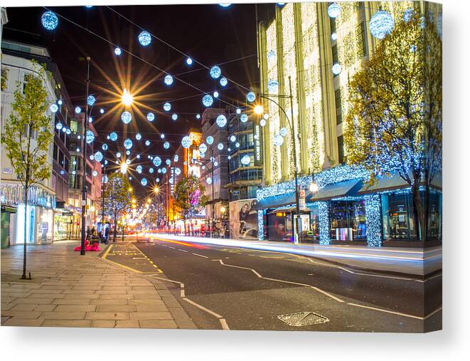 Christmas Canvas Print featuring the photograph Christmas in Oxford Street by Andrew Lalchan