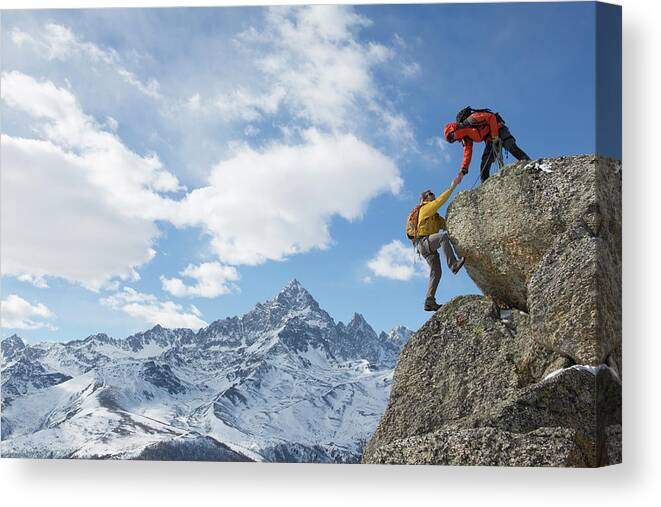 Young Men Canvas Print featuring the photograph Climber Extends Helping Hand To Teammate by Ascent Xmedia