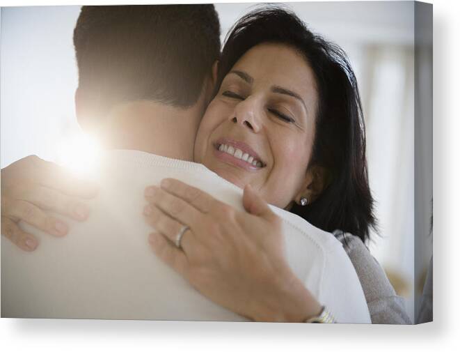 Heterosexual Couple Canvas Print featuring the photograph Close up of couple hugging by JGI/Jamie Grill