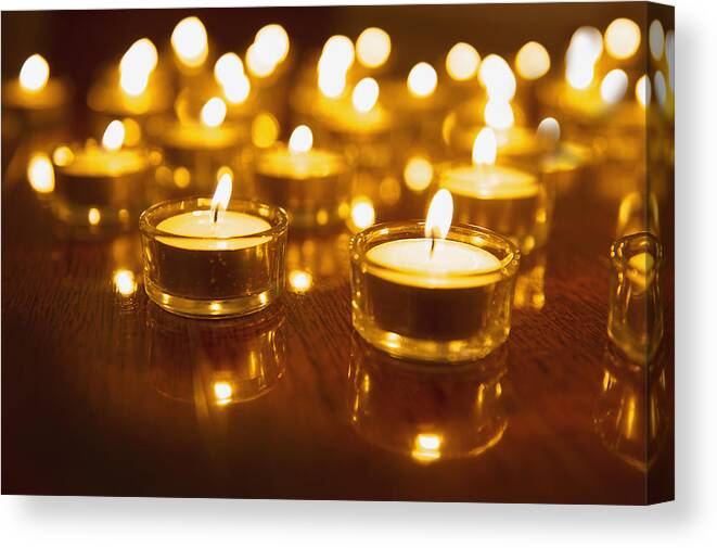 Tranquility Canvas Print featuring the photograph Close up of lit tea light candles on wooden table by Jacobs Stock Photography Ltd