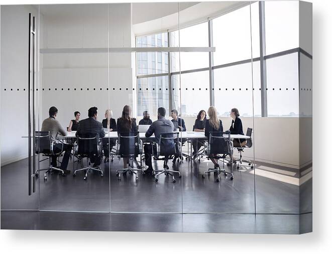 Working Canvas Print featuring the photograph Colleagues at business meeting in conference room by FangXiaNuo