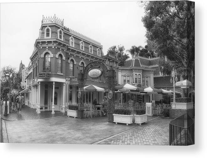 Main Street Canvas Print featuring the photograph Corner Cafe Main Street Disneyland BW by Thomas Woolworth